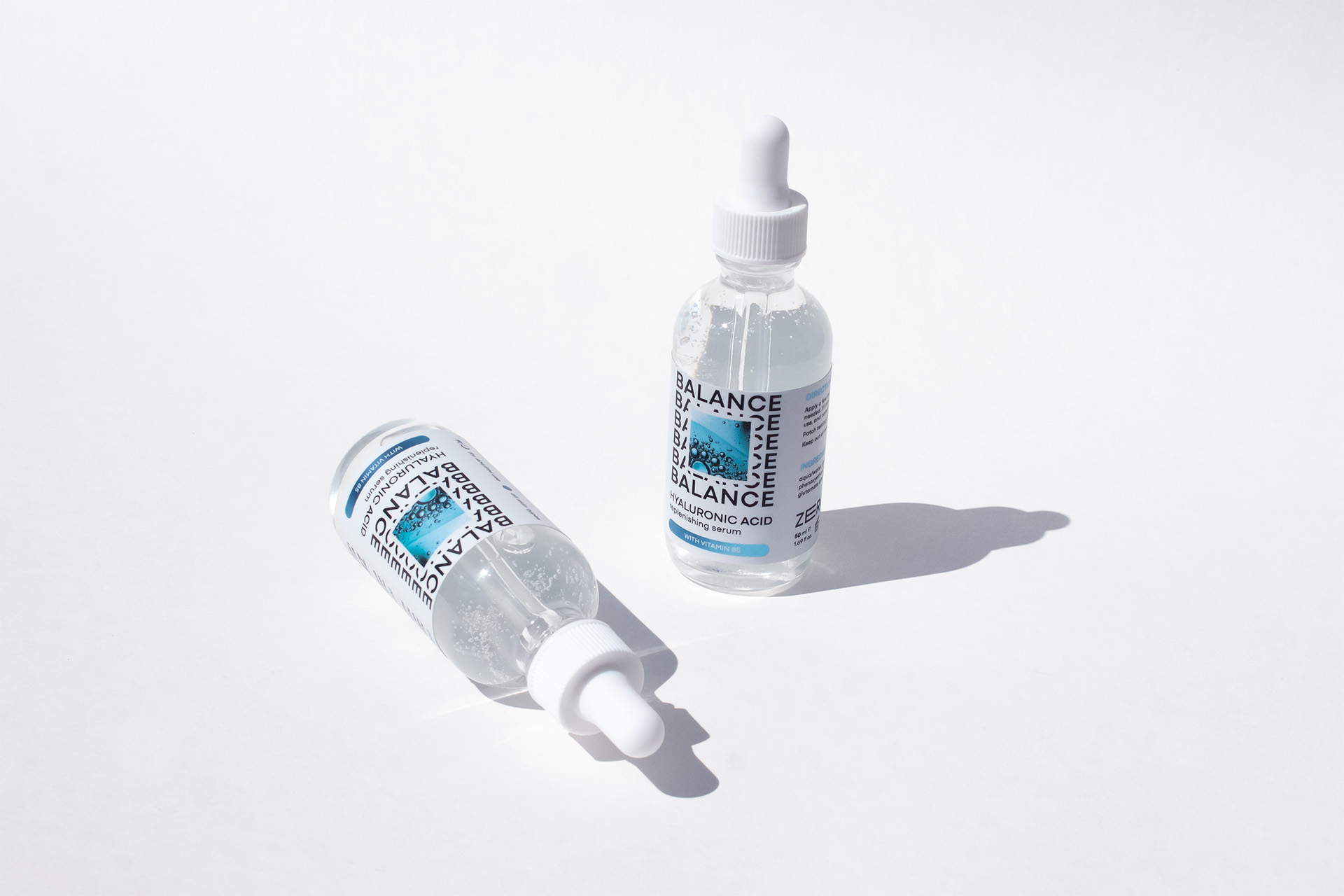 image of two hyaluronic acid serum bottles with extended content label on metallized film
