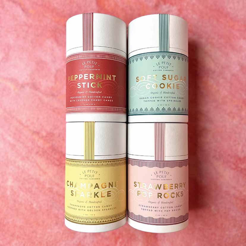 Vibrant cotton candy tubs with custom gold hot-stamped labels, featuring intricate designs that enhance the packaging's appeal and make the product stand out.